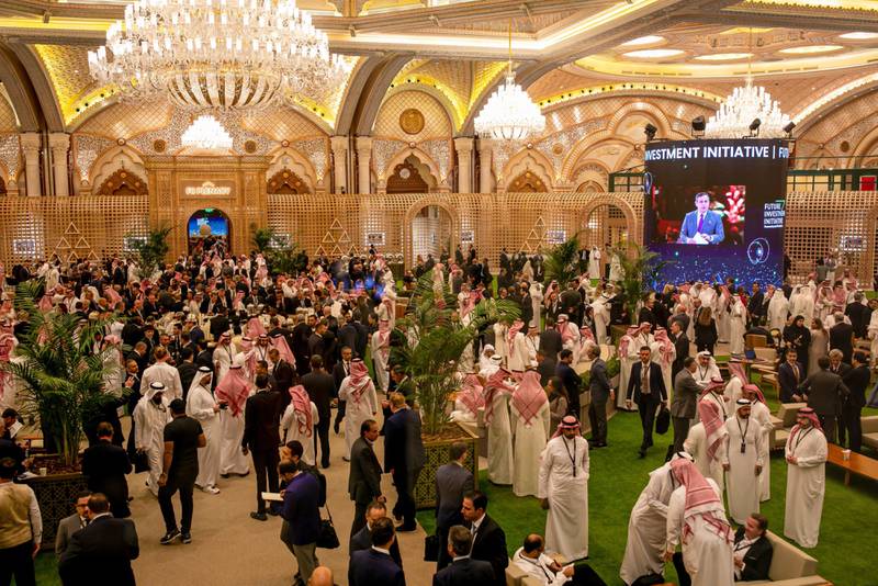 Attendees in a hall between sessions at the Future Investment Initiative (FII) conference in Riyadh, Saudi Arabia, on Tuesday, Oct. 25, 2022.